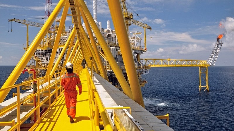 man walking on oil rig